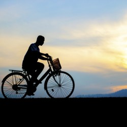 Children enjoy ride bicycle during sunset
